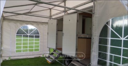 Demi marquee butted up against portable toilet units